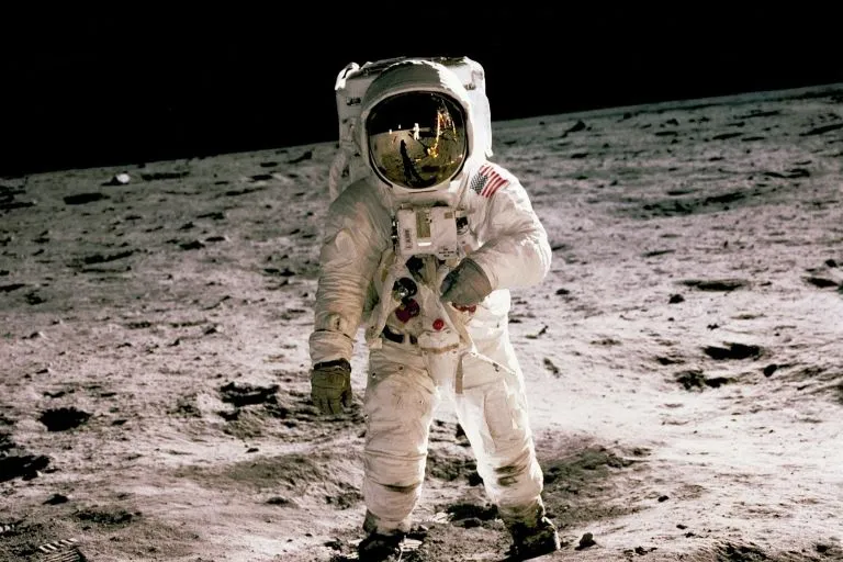 Un astronauta con su traje espacial pisando la luna